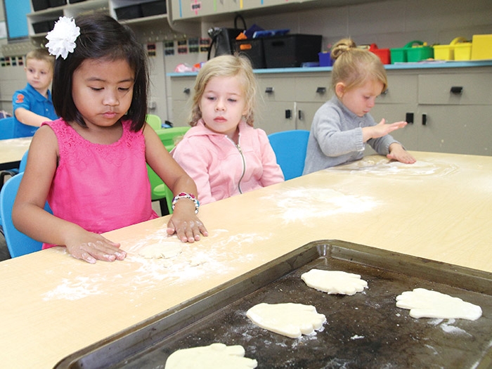 <b>First week of school</b> Classes started in the Southeast Cornerstone School Division last Tuesday. At left are MacLeod Elementary School Kindergarten students Jaeden, Evann and Kaydence making “kissing hand” cookies on their third day of class after reading a story called “The Kissing Hand” in Mrs. McMullen’s class.